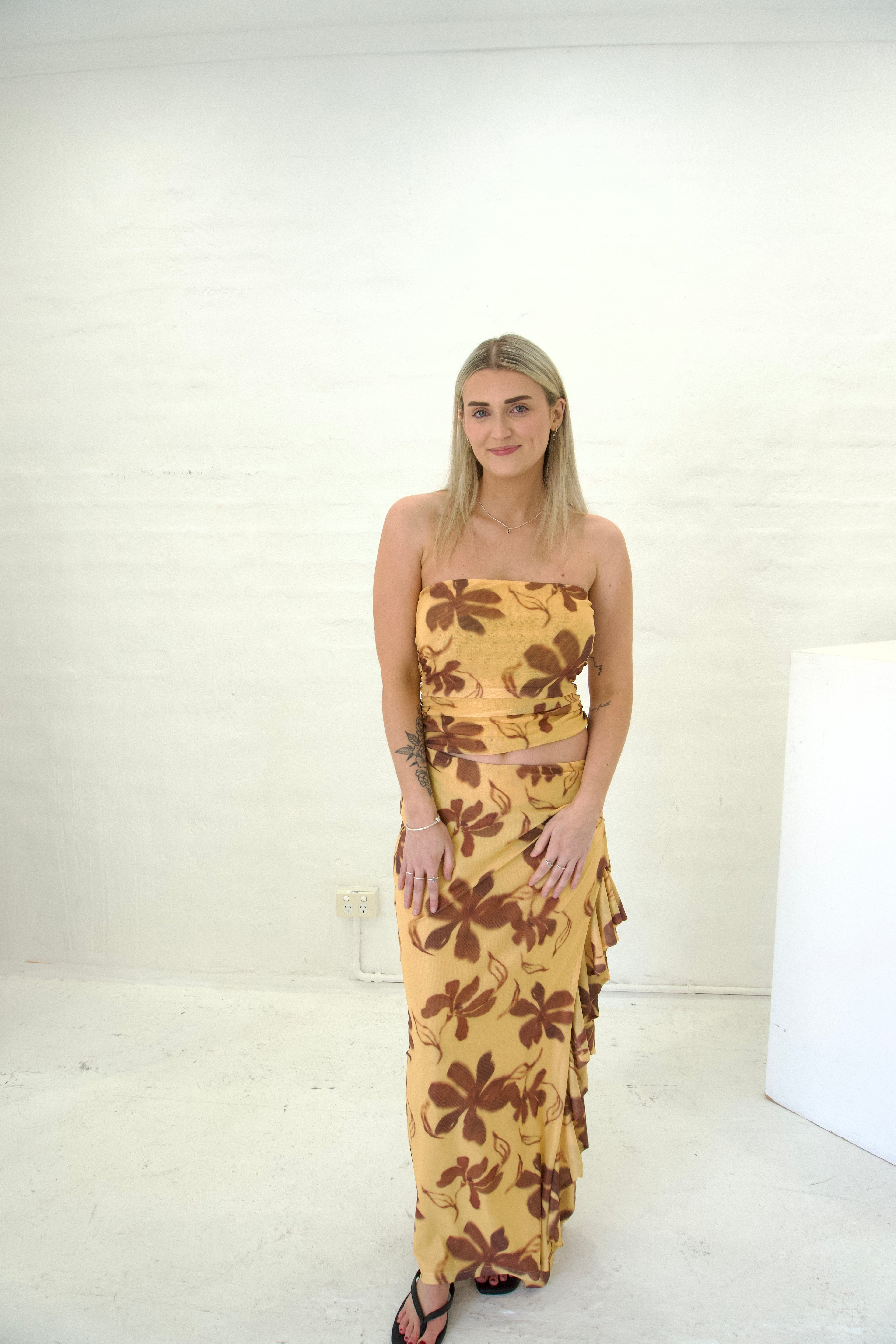 Woman wearing a floral dress against a white background