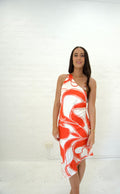 Woman wearing a red and white patterned dress against a white background. - @sarahmadden