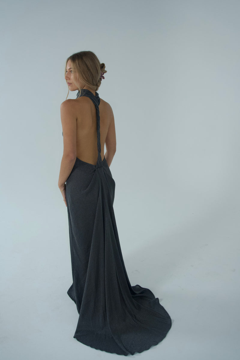 Women wearing a metallic turtle neck gown in front of a white backdrop.  - @indiabluegranger