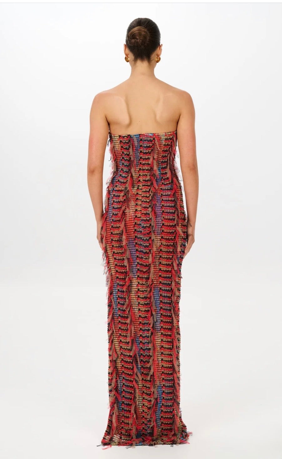 Back of the red maxi dress on a girl in front of a white backdrop.