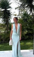 Woman in a light blue dress standing outdoors with greenery in the background. - @brileyclifford
