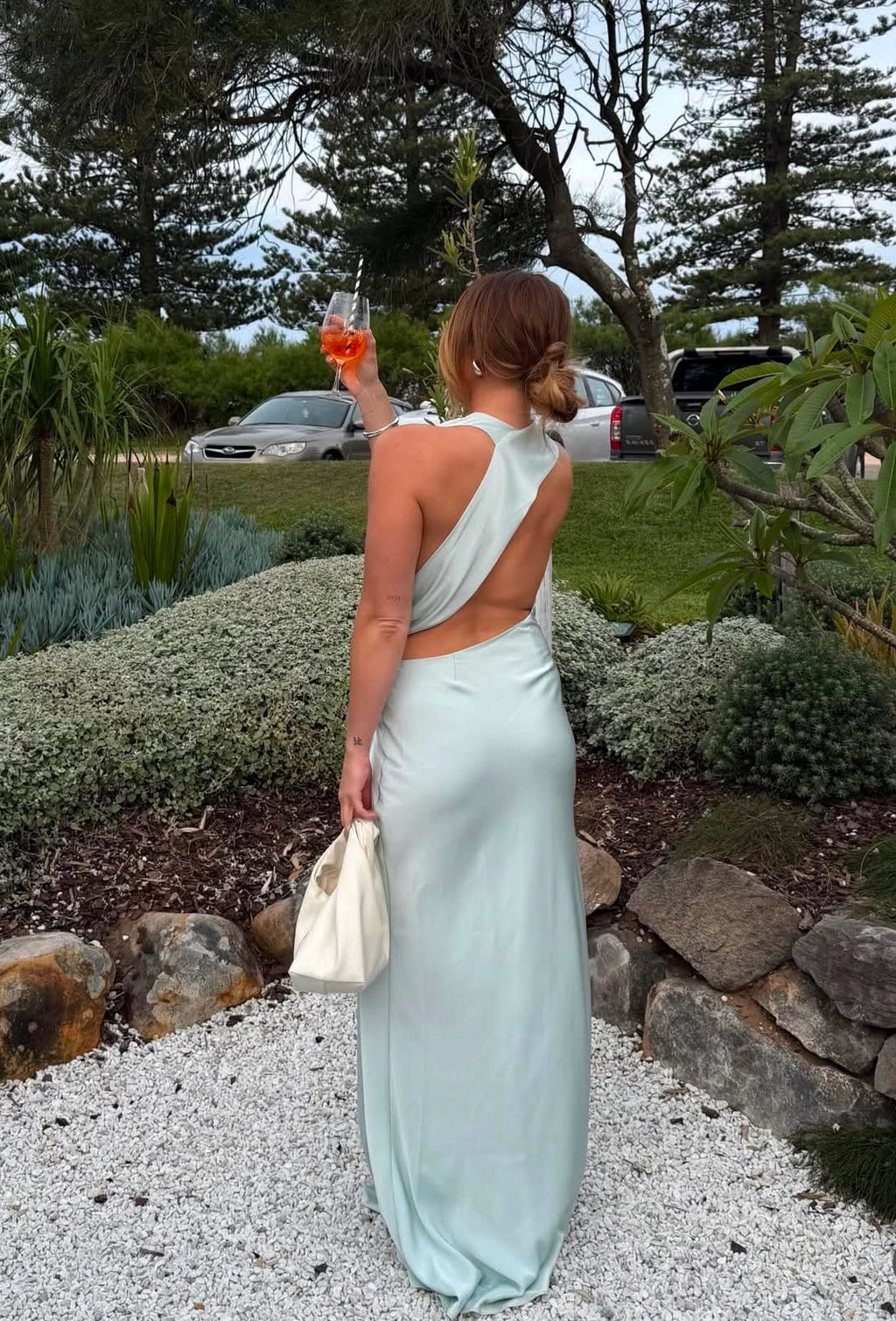 Girl in blue dress holding a glass