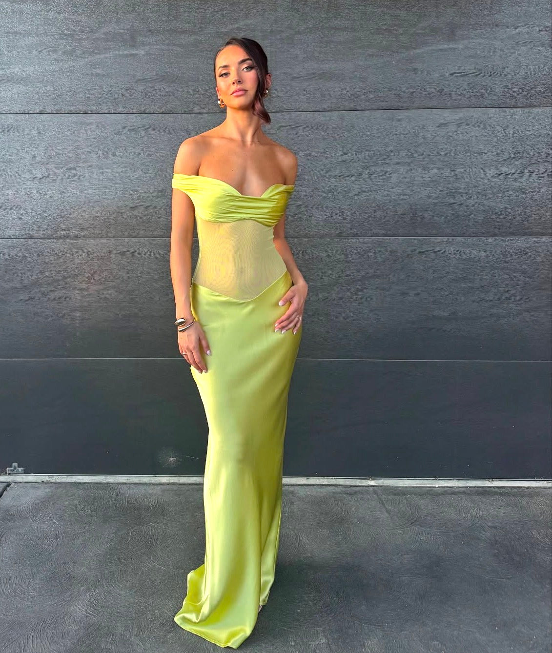 Woman in a bright yellow off-shoulder gown against a dark background - @chelseabalzan_
