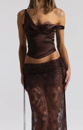 Posed photo wearing a 2 piece set. Brown top paired with a brown lace skirt,