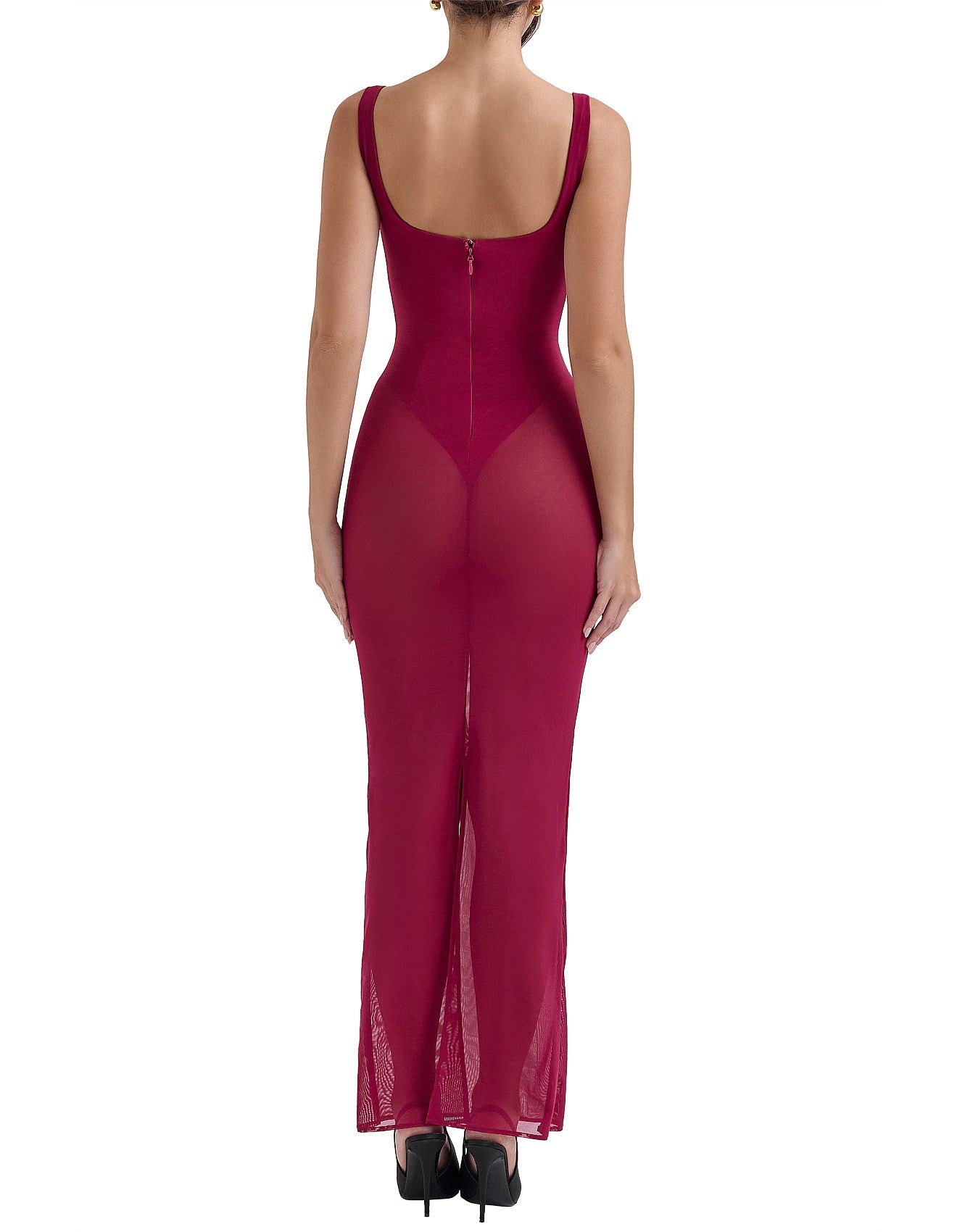 Woman wearing a magenta evening gown with sheer panels on a white background.