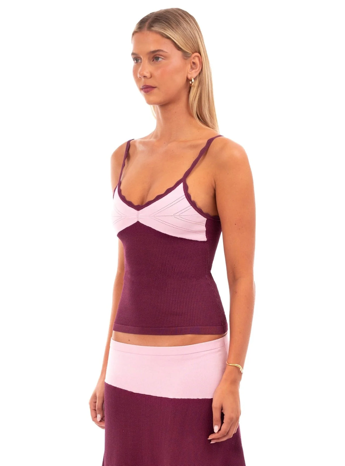 Woman wearing the Camilla Knit Set in pink and purple, featuring a fitted sweetheart neckline tank top with thin straps.