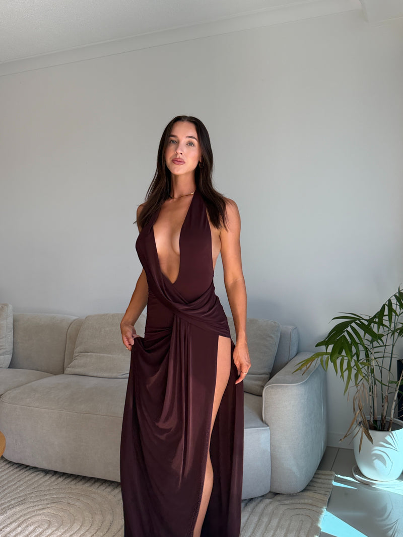 Woman in a deep neckline dress with a high slit standing in a living room. - @alesha.beggs
