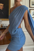 Close-up of the Arcina Ori Fernanda Mini Dress in Blue, featuring a draped one-shoulder neckline, open side detailing, ruched fitted mini skirt and flowing sash.
