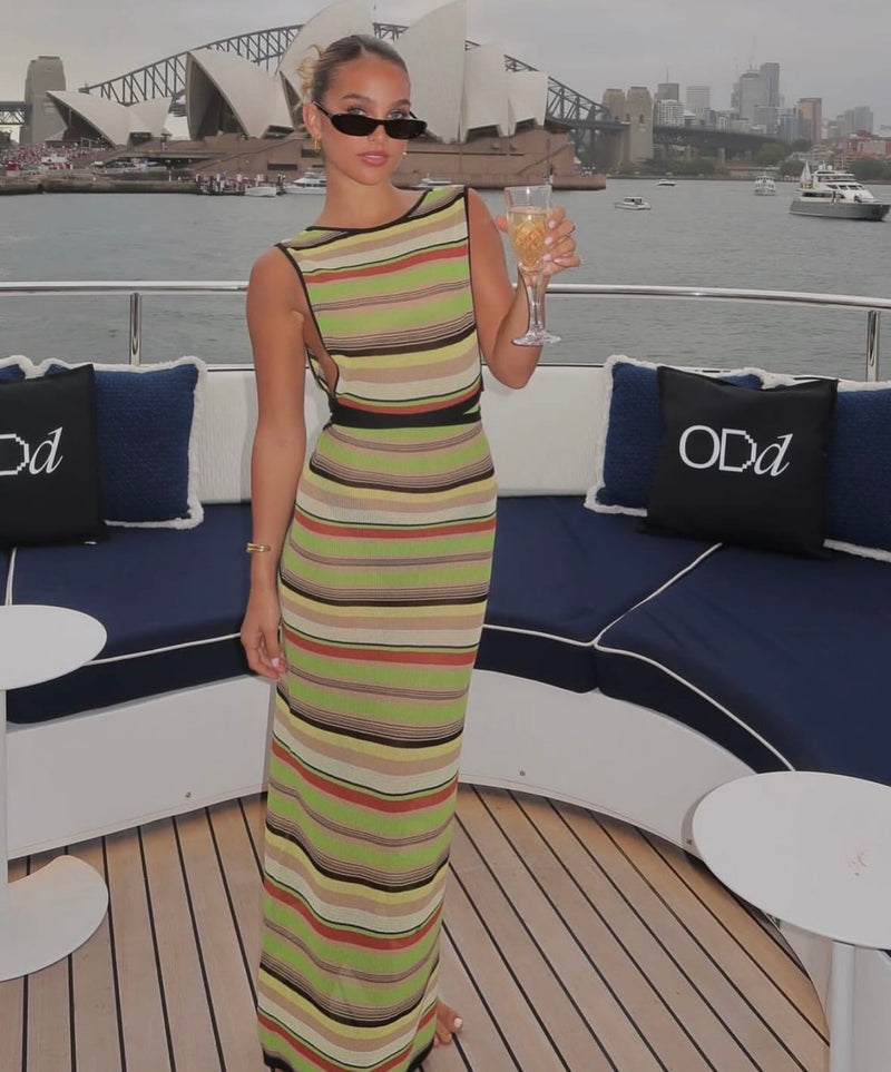 Woman in a striped dress on a boat with Sydney Harbour Bridge in the background. - @SamGuggenheimer