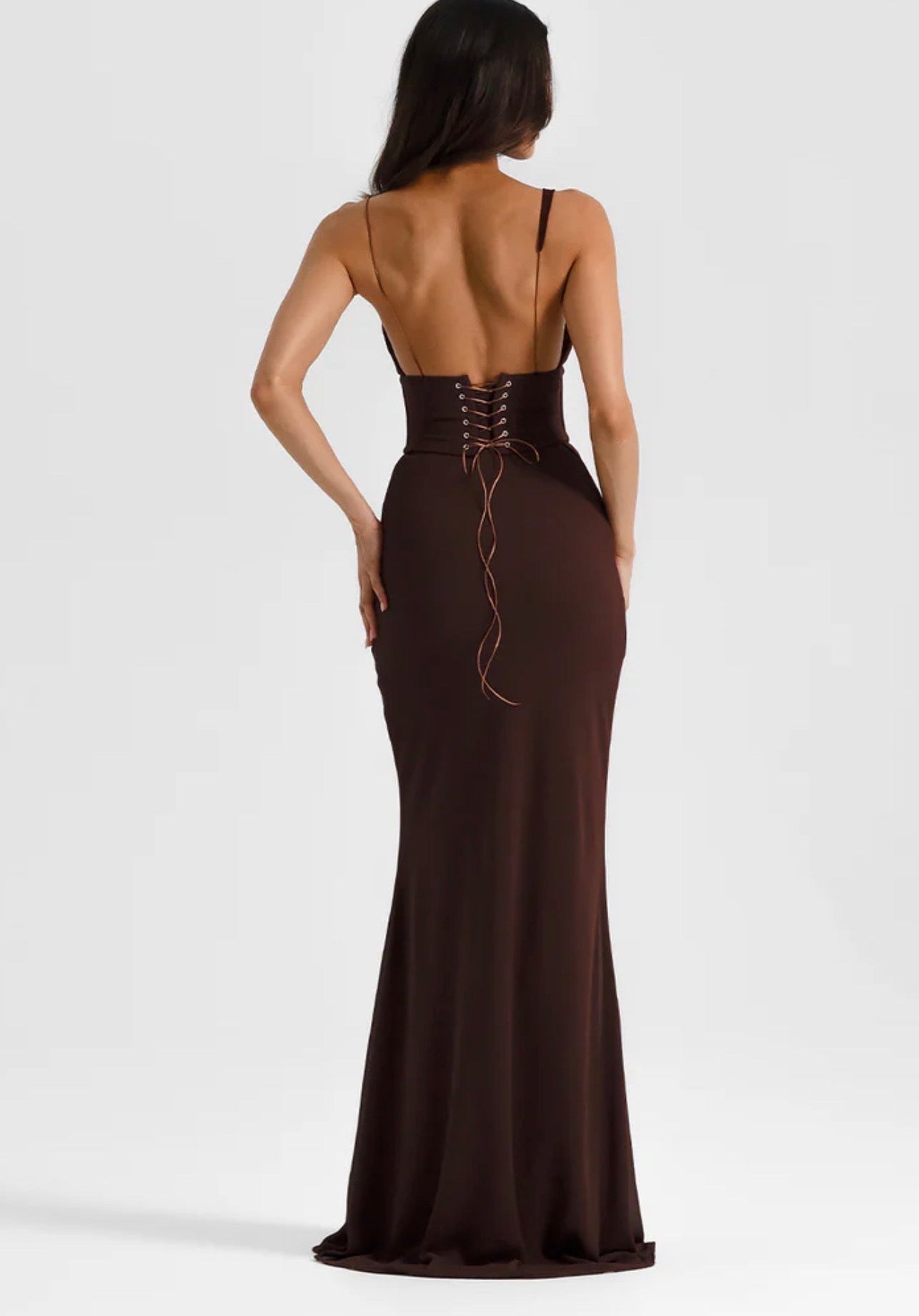 Brown evening gown with open back on a white background