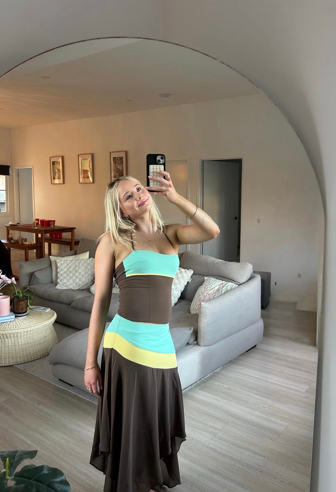Woman taking a mirror selfie in a living room