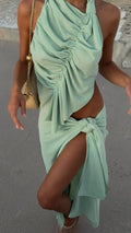 Woman wearing a light green dress with a beach setting
