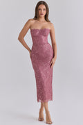 Model wearing the House of CB Alexia Amethyst Metallic Lace Strapless Midi Dress in dusty rose pink, featuring a structured corset bodice, underwired cups, delicate floral lace and scalloped hem, paired with nude heels against a light grey studio background.
