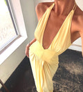 Yellow dress with a deep neckline worn by a person indoors.