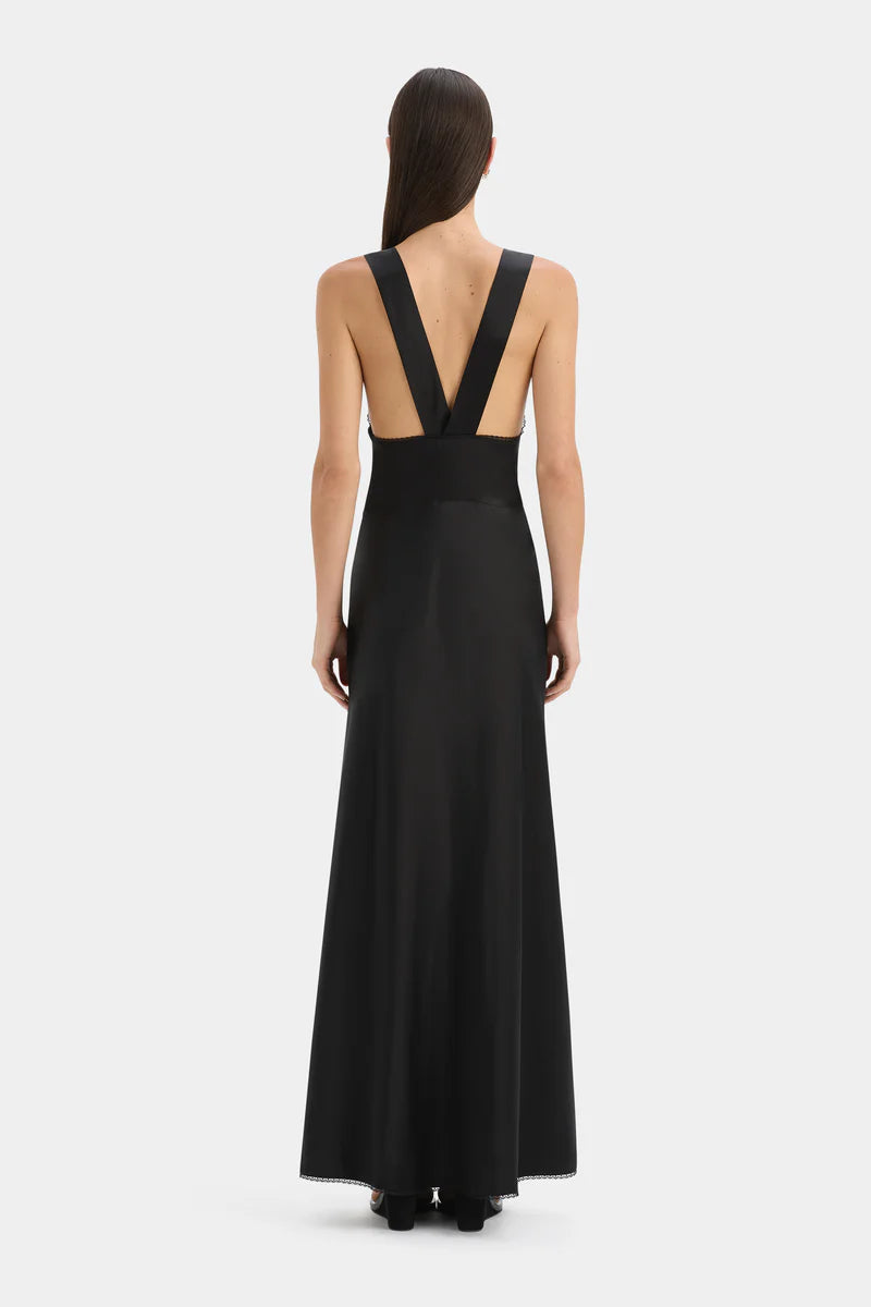 Black evening gown with open back on a white background