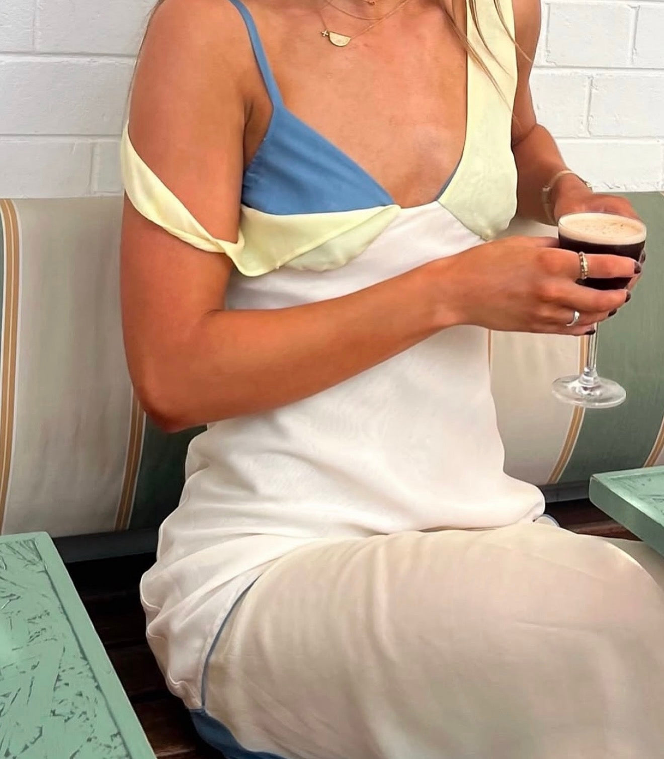 Woman holding a glass of red wine in a casual setting
