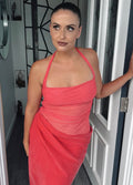 Woman in a pink dress standing in a doorway. - @gabmoore